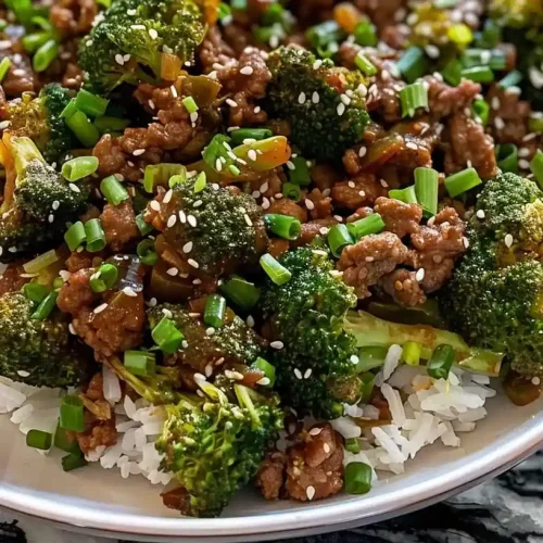 ground beef and broccoli stir fry with rice on a plate